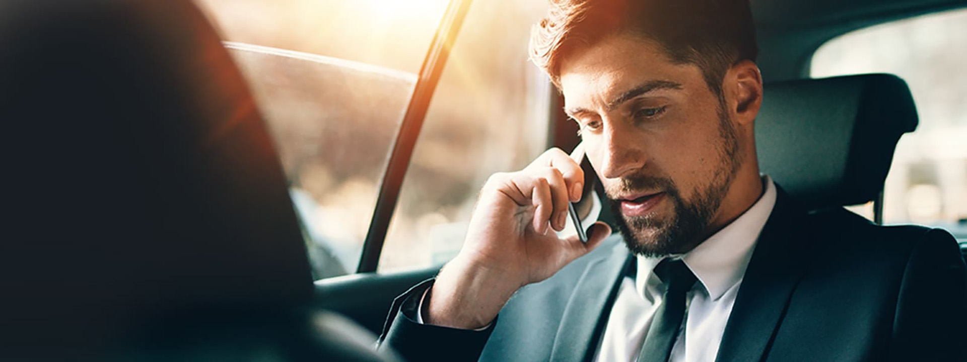 A man talking on the phone in a taxi