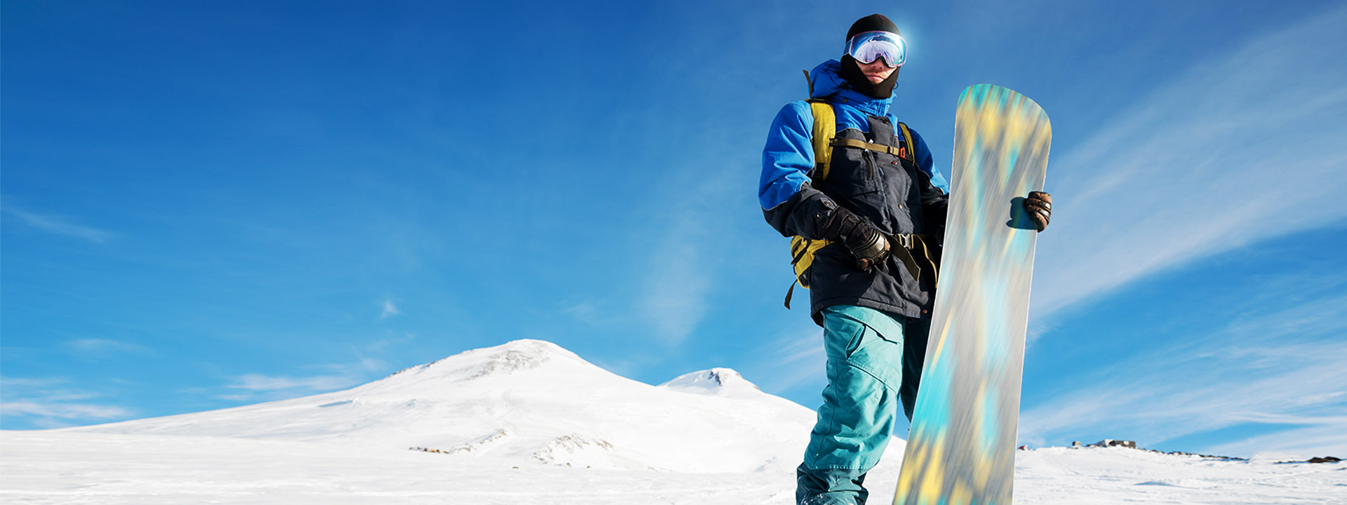 A man holding a snowboard