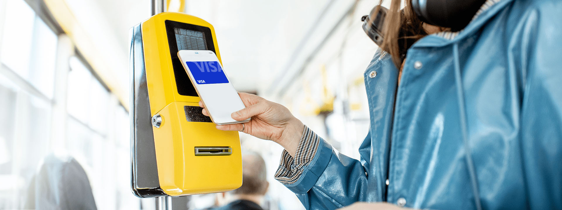 A person using a phone to pay for a ticket