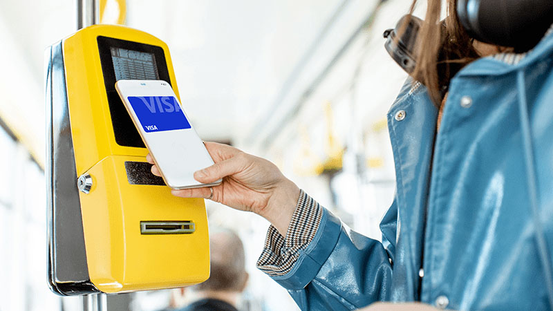 A person using a phone to pay for a ticket