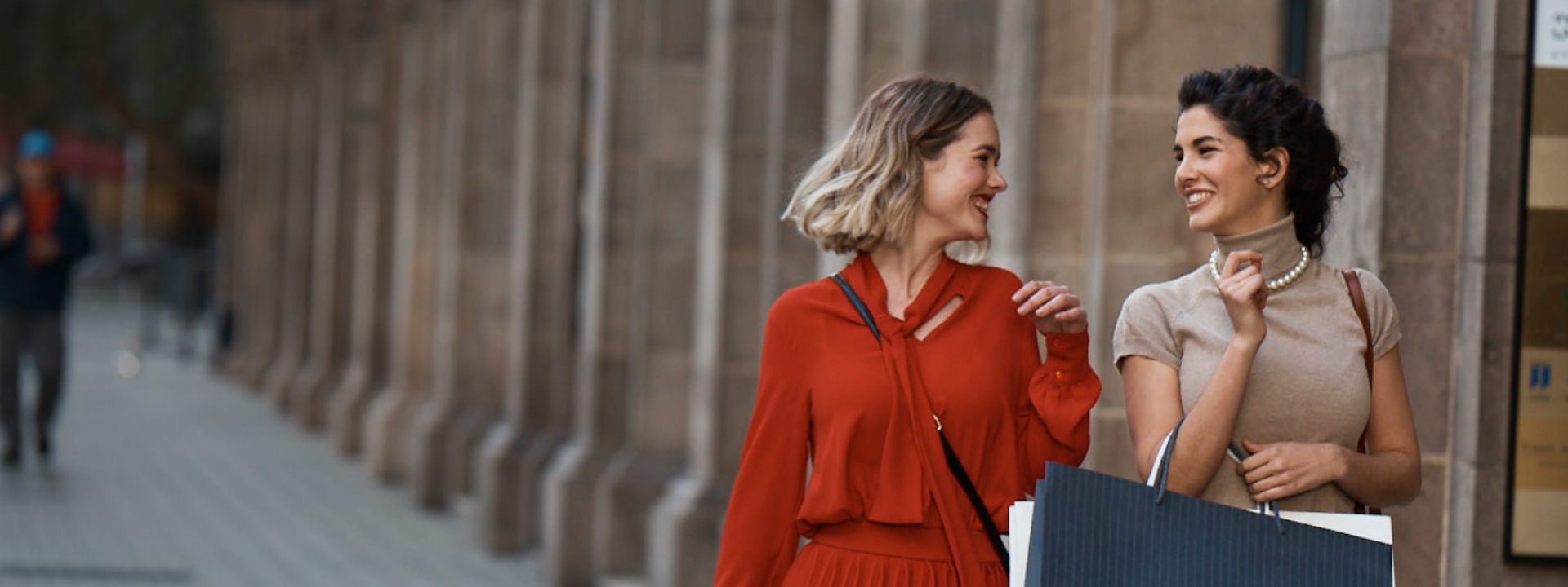 Two women going along the street with shopping bags