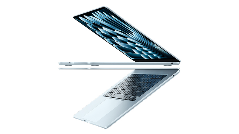 A silver laptop partially open, viewed from the side, displaying a geometric blue pattern on the screen and a visible keyboard.