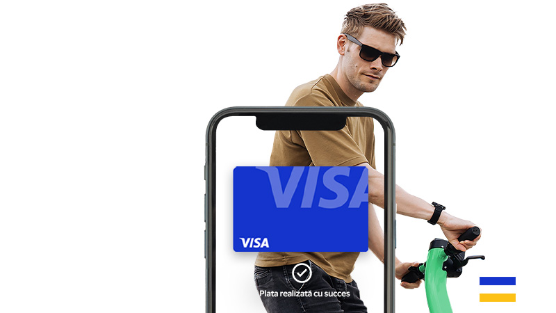A man wearing sunglasses riding an electric scooter is seen behind a smartphone displaying a Visa card on its screen. The text on the phone reads "Paga tu renta con tus cuates.