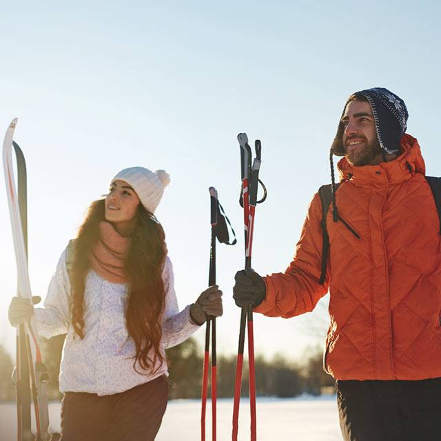 A man and a woman with skis
